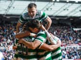 Celtic's Alistair Johnston jumps on top of his team-mates following Cameron Carter-Vickers' goal in the 3-0 win over Hearts.