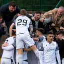 Edinburgh City's Innes Murray (29) celebrates his goal with fans against Annan Athletic.