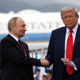 US President Donald Trump and Russian President Vladimir Putin shake hands after their arrival for summit in Alaska (Picture: Gavriil Grigoriv/Pool/AFP via Getty Images)