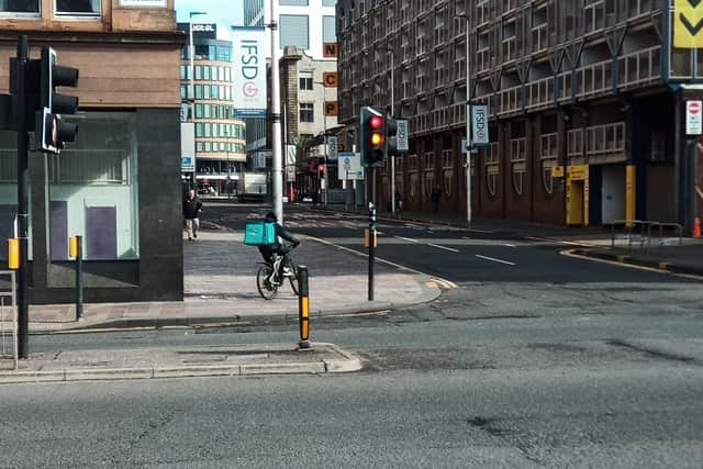 A delivery cyclist riding on the pavement in Glasgow city centre (Picture: The Scotsman)