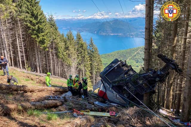 Rescuers work by the wreckage of a cable car after it collapsed near the summit of the Stresa-Mottarone line in the Piedmont region, northern Italy. (Credit: Soccorso Alpino e Speleologico Piemontese via AP)