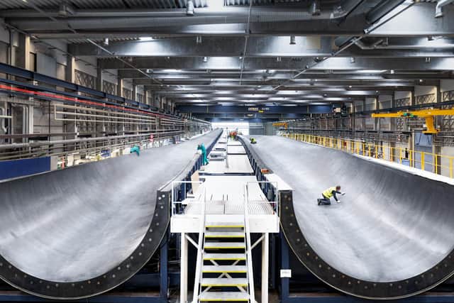 Final checks are made on a giant wind turbine blade mould at the Vestas factory in Nakskov, Denmark