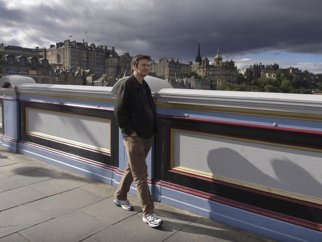 Rebus author Ian Rankin walking across North Bridge in 2006.