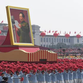 A giant portrait of former Chinese Communist Party leader Mao Zedong passes by Tiananmen Square during a National Day parade in Beijing (Picture: Greg Baker/AFP via Getty Images)