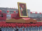 A giant portrait of former Chinese Communist Party leader Mao Zedong passes by Tiananmen Square during a National Day parade in Beijing (Picture: Greg Baker/AFP via Getty Images)