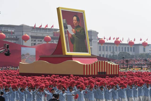 A giant portrait of former Chinese Communist Party leader Mao Zedong passes by Tiananmen Square during a National Day parade in Beijing (Picture: Greg Baker/AFP via Getty Images)