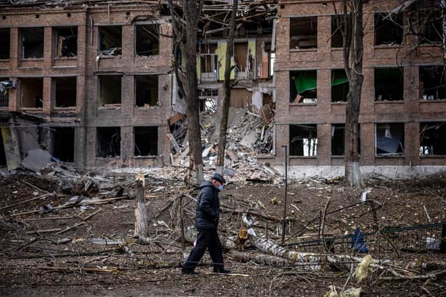 A man walks in front of a destroyed building after a Russian missile attack in the town of Vasylkiv, near Kyiv. Picture: Dimitar Dilkoff/AFP/Getty
