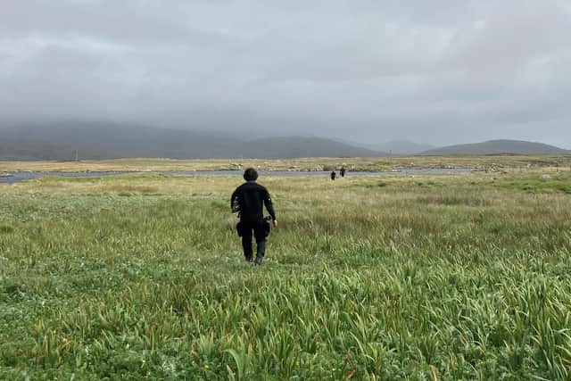 A member of the Islands of Stone team walks to the loch as the search begins for crannog sites. PIC: Islands of Stone.
