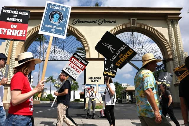 Striking WGA (Writers Guild of America) members picket with striking SAG-AFTRA members outside Paramount Studios earlier this month in Los Angeles, California.