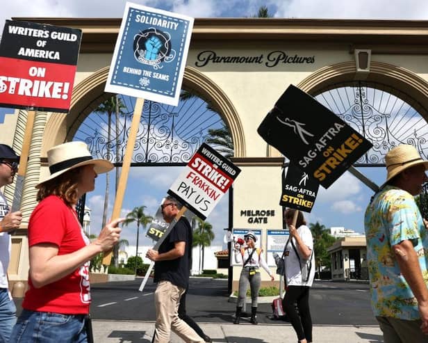 Striking WGA (Writers Guild of America) members picket with striking SAG-AFTRA members outside Paramount Studios earlier this month in Los Angeles, California.