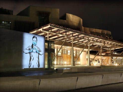 The image was projected on to the Scottish Parliament on Christmas Eve. (Stewart Attwood/PA)