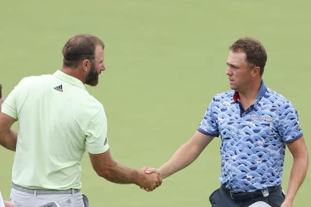 Justin Thomas, right, shakes hands with Dustin Johnson at the end of the second round in Oklahoma. Picture: Christian Petersen/Getty Images.