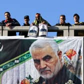 Mourners stand on a bridge during a funeral procession for Iranian general Qasem Soleimani, killed outside Baghdad airport in January 2020 by a US drone strike (Picture: Atta Kenare/AFP via Getty Images)