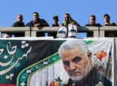 Mourners stand on a bridge during a funeral procession for Iranian general Qasem Soleimani, killed outside Baghdad airport in January 2020 by a US drone strike (Picture: Atta Kenare/AFP via Getty Images)