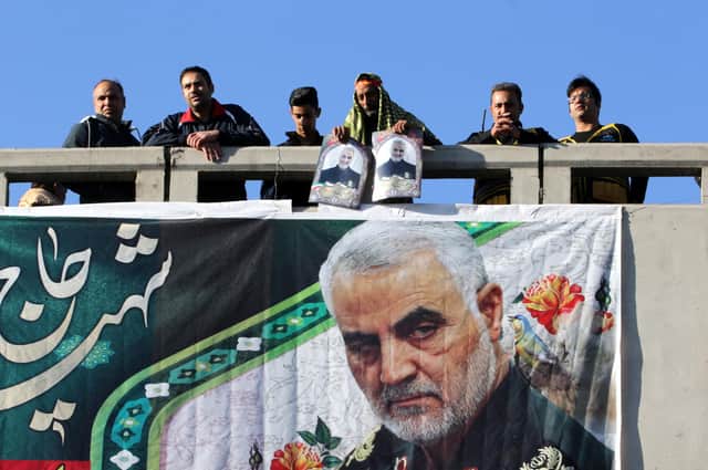 Mourners stand on a bridge during a funeral procession for Iranian general Qasem Soleimani, killed outside Baghdad airport in January 2020 by a US drone strike (Picture: Atta Kenare/AFP via Getty Images)