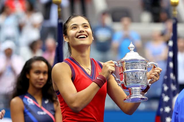 Emma Raducanu lifts the US Open trophy after beating Leylah Fernandez.