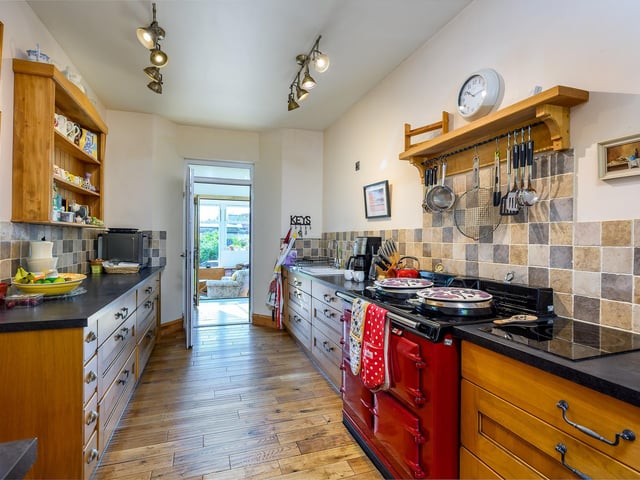 Interior: Its ground floor has solid oak flooring throughout and features a kitchen with Aga, and a large dining room with fireplace and bi-folding doors to the orangery. Upstairs, the third bedroom could be an ideal study.