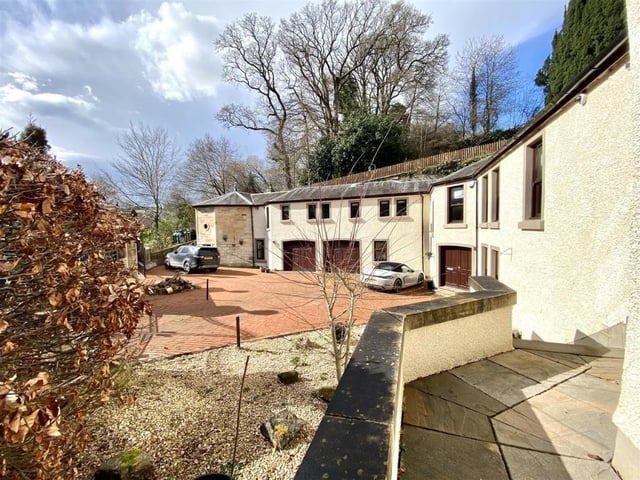 Front of property and paved courtyard.