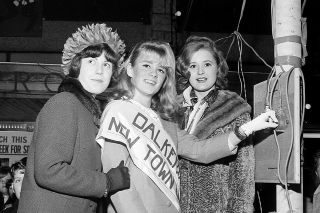 Dalkeith's New Town Girl, 18 year-old Joan Hepburn, switches on the Town Christmas Lights in 1964 watched by runners-up Ruth Wysick and Teresa O'Brien.