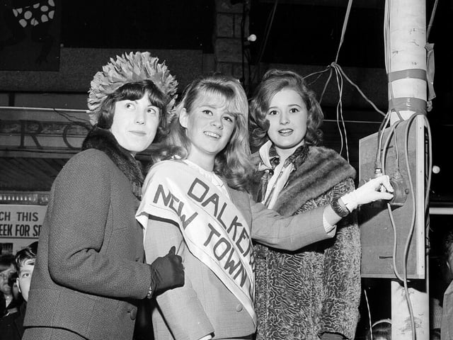 Dalkeith's New Town Girl, 18 year-old Joan Hepburn, switches on the Town Christmas Lights in 1964 watched by runners-up Ruth Wysick and Teresa O'Brien.