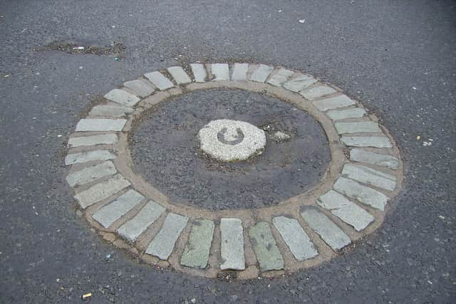 Original plaque pinpointing the place where the accused witches were buried after being hung and burnt at Galllows Green.