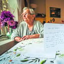 Irena Jendrycha with the card she received in the post from a stranger wishing her well