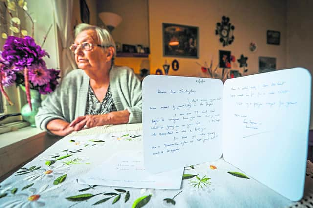 Irena Jendrycha with the card she received in the post from a stranger wishing her well