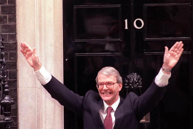Prime Minister John Major waves to supporters in Downing Street after his shock victory in the 1992 general election (Picture: Jim James/PA)