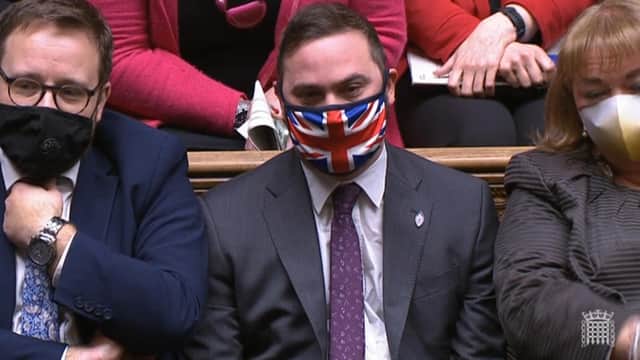 A view of Bury South MP Christian Wakeford sitting on the opposition benches during Prime Minister's Questions in the House of Commons, London.