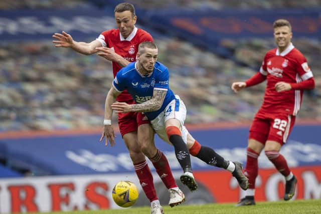 Aberdeen's Andy Considine (left) with Rangers' Ryan Kent  during the Scottish Premiership match  between Rangers and Aberdeen  at Ibrox Stadium, on May 15, 2021. (Photo by Craig Williamson / SNS Group)