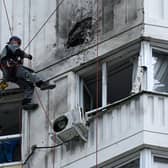 A specialist inspects the damaged facade of a multi-storey apartment building after a reported drone attack in Moscow on Tuesday. Picture: AFP via Getty Images