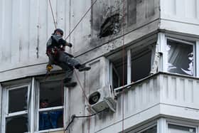 A specialist inspects the damaged facade of a multi-storey apartment building after a reported drone attack in Moscow on Tuesday. Picture: AFP via Getty Images