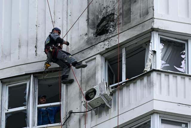 A specialist inspects the damaged facade of a multi-storey apartment building after a reported drone attack in Moscow on Tuesday. Picture: AFP via Getty Images