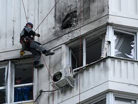 A specialist inspects the damaged facade of a multi-storey apartment building after a reported drone attack in Moscow on Tuesday. Picture: AFP via Getty Images