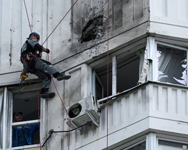 A specialist inspects the damaged facade of a multi-storey apartment building after a reported drone attack in Moscow on Tuesday. Picture: AFP via Getty Images