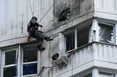 A specialist inspects the damaged facade of a multi-storey apartment building after a reported drone attack in Moscow on Tuesday. Picture: AFP via Getty Images
