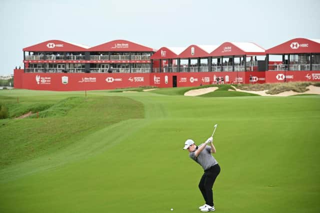 Bob MacIntyre plays his third shot on the 18th hole during the first day of the Abu Dhabi HSBC Championship at Yas Links. Picture: Ross Kinnaird/Getty Images.