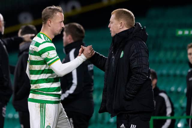 Leigh Griffiths (L) shakes the hand of manager Neil Lennon after being substituted during Celtic's 2-0 win over Ross County. The striker scored his side's second goal. (Photo by Craig Williamson / SNS Group)