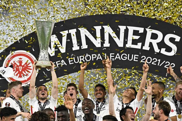 Frankfurt's Serbian midfielder Filip Kostic lifts the trophy as Eintracht Frankfurt players celebrate after winning the UEFA Europa League final football match between Eintracht Frankfurt and Glasgow Rangers at the Ramon Sanchez Pizjuan stadium in Seville on May 18, 2022.  (Photo by JAVIER SORIANO/AFP via Getty Images)
