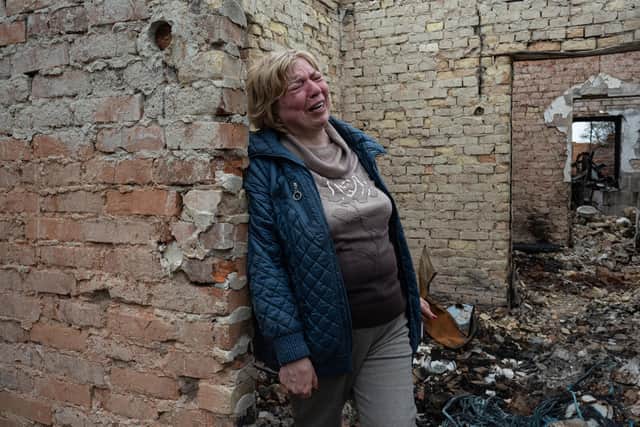 Inna, 53, weeps inside her burnt-out house in Ozera, Ukraine (Picture: Alexey Furman/Getty Images)