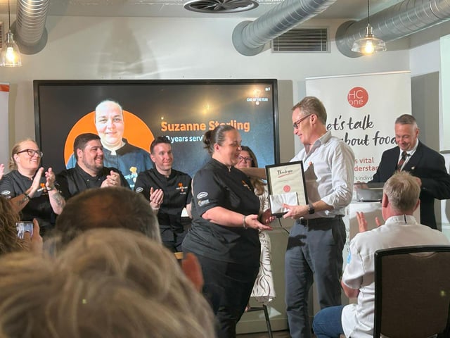 Suzanne Stirling, Group Development Chef at HC-One being presented with her 20 year long service award by James Tugendhat, Chief Executive Officer at HC-One at the HC-One Chef of the Year Competition 2025