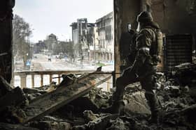 A Russian soldier in the ruins of the Mariupol drama theatre, bombed in March last year despite a large sign saying children were sheltering there (Picture: Alexander Nemenov/AFP via Getty Images)