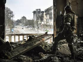 A Russian soldier in the ruins of the Mariupol drama theatre, bombed in March last year despite a large sign saying children were sheltering there (Picture: Alexander Nemenov/AFP via Getty Images)