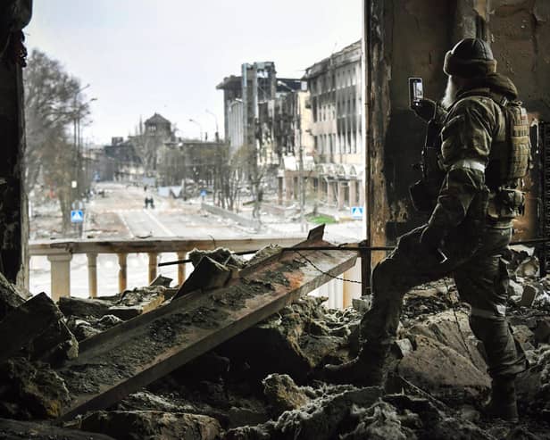 A Russian soldier in the ruins of the Mariupol drama theatre, bombed in March last year despite a large sign saying children were sheltering there (Picture: Alexander Nemenov/AFP via Getty Images)