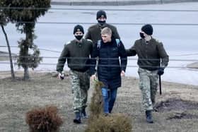 Law enforcement officers detain a man in Minsk, last year during protests against the Belarusian government. More than 1,000 people are believed to be political prisoners in the country.