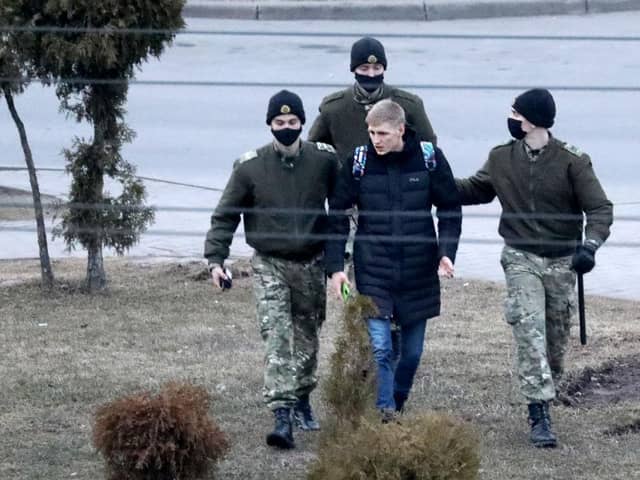 Law enforcement officers detain a man in Minsk, last year during protests against the Belarusian government. More than 1,000 people are believed to be political prisoners in the country.