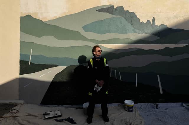 Donnie Munro with his mural of The Storr in Portree. PIC: Gavin Major.