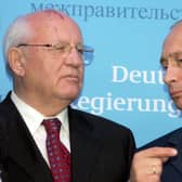 File photo taken on December 21, 2004 Russian President Vladimir Putin (R) talks to former Soviet President Mikhail Gorbachev (L) prior to a joint press conference of German Chancellor Gerhard Schroeder and Putin at Gottorf castle in Schleswig. Russian President Vladimir Putin said on August 31, 2022 that Mikhail Gorbachev, made a 'huge impact' on world history. (Photo by Alexander NEMENOV / AFP) (Photo by ALEXANDER NEMENOV/AFP via Getty Images)
