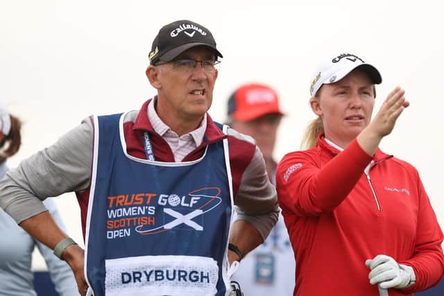 Gemma Dryburgh sizes up a shot with caddie Paul Heselden in the first round of the Trust Golf Women's Scottish Open at Dundonald Links.