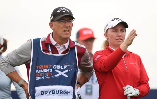 Gemma Dryburgh sizes up a shot with caddie Paul Heselden in the first round of the Trust Golf Women's Scottish Open at Dundonald Links.
